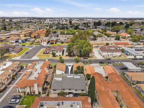 Aerial elevation of 12582 Adelle showing the front driveway running between two flanking single-story garage rows toward the front building